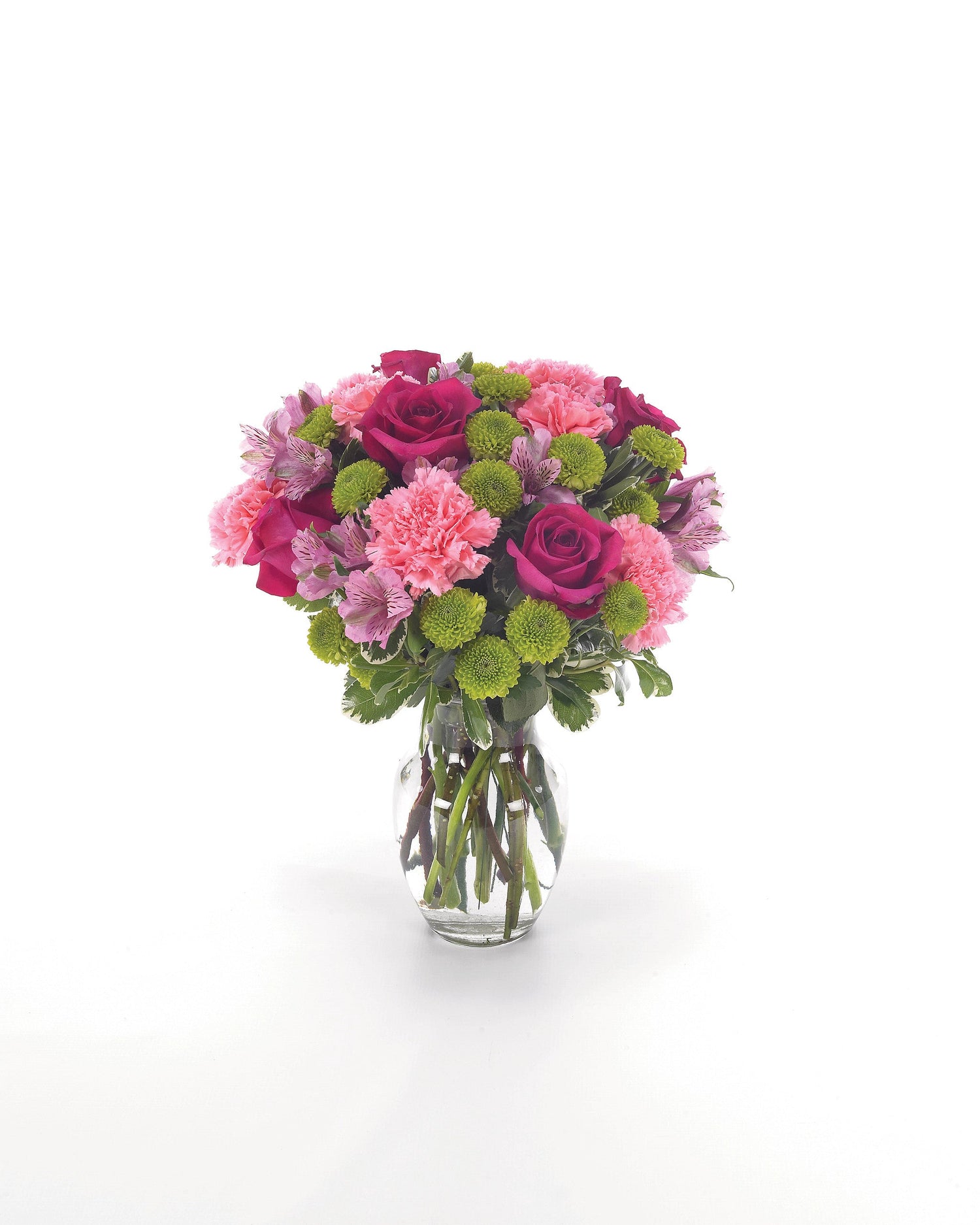Bouquet of pink and green flowers in a clear vase on a white background