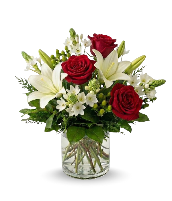 Bouquet of red roses and white lilies in a clear vase on a white background